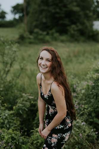 people shallow focus photography of woman posing and smiling at camera woman