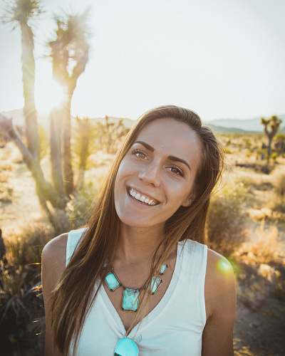 woman smiling woman near tree people