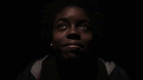 people woman in gray and black shirt surrounded with darkness woman