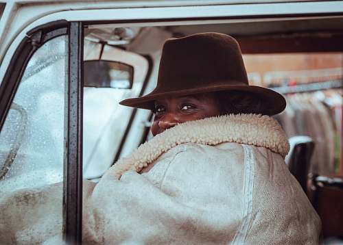 lady woman sitting in beige vehicle hat