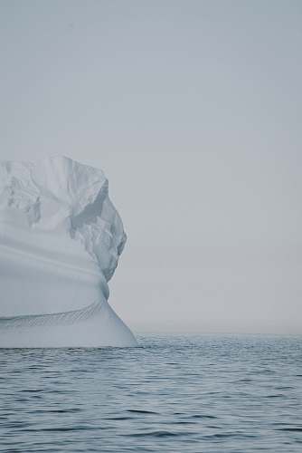 grey selective focus photo of iceberg on large body of water at winter iceberg