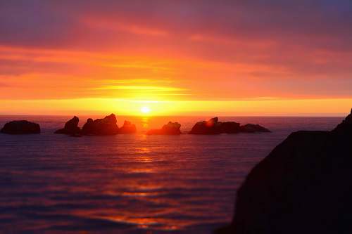 nature rocks on sea under sunset landscape
