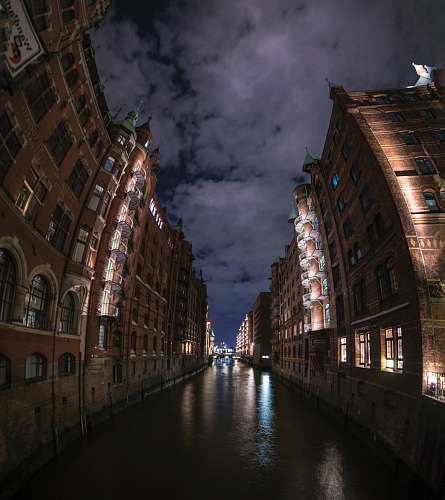 water brown and black concrete building during nighttme speicherstadt