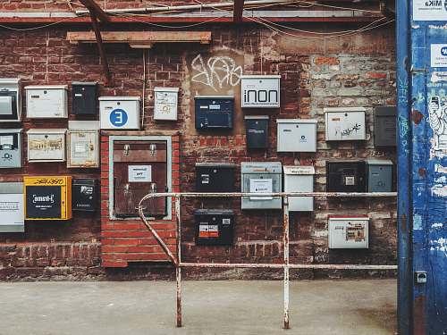 cologne metal boxes on brown brick wall machine