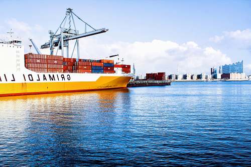 boat white and orange cargo ship with metal lifting equipment hamburg