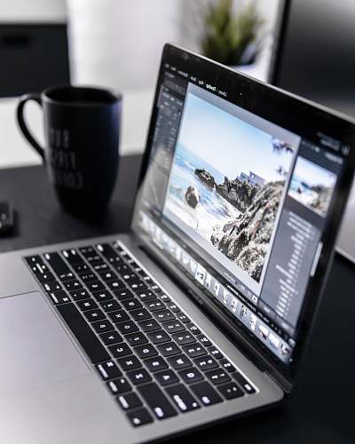 computer turned-on MacBook Pro on desk electronics