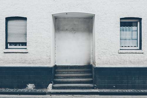 grey close up photo of white and black concrete building's entrance satzvey