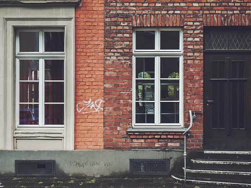 brick closed brown wooden door köln