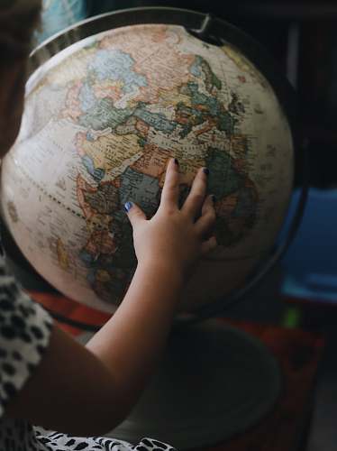 person white and beige desk globe people