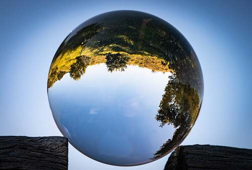 astronomy reflection of trees and sky on clear ball outer space