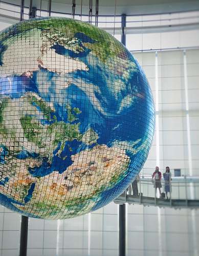 astronomy two woman standing beside earth scale globe