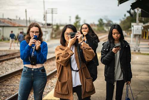 clothing four women standing by the railroad denim