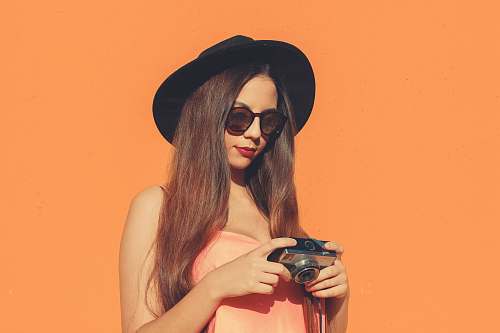 clothing woman holding camera hat