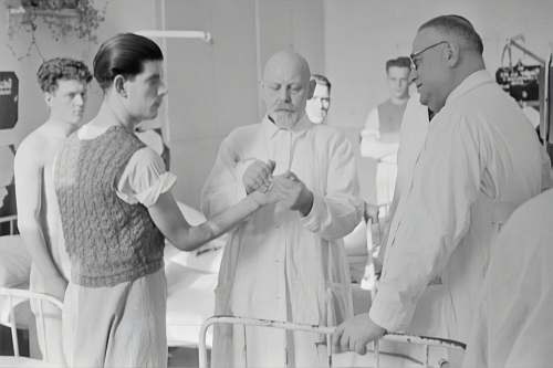 human grayscale photography of man in lab gown grey