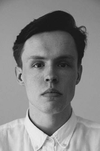 head grayscale photography of man wearing collar top face