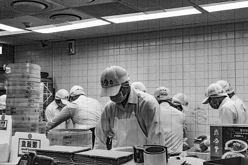 apparel grayscale photography of workers inside room clothing