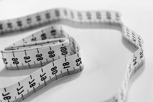 grey selective focus photography of tape measure measure