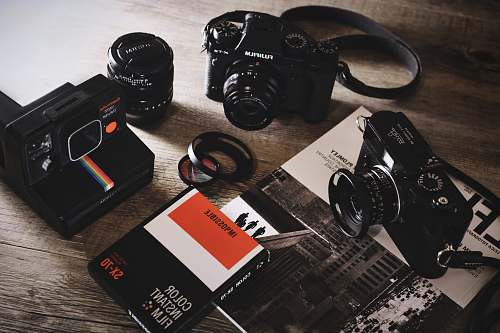 photo black box surround by three cameras equipment