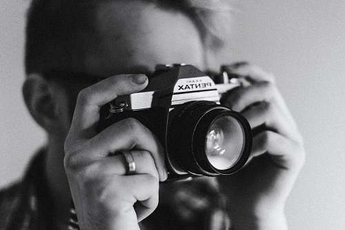 black-and-white grayscale photo of man taking photo photographer