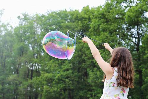 people girl making bubbles during daytime bubble