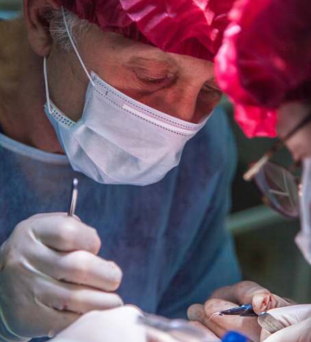 person surgeon wearing white mask and pink hat human