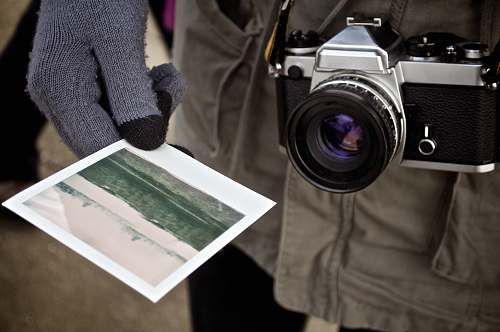 camera person holding photo photography