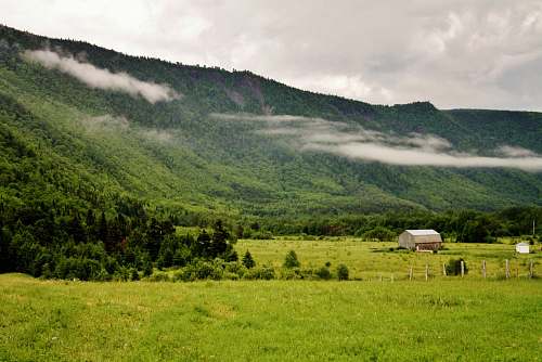 farm brown house near mountain peak pasture