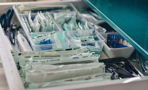 drawer white packs with scissors and medicine on gray tray test