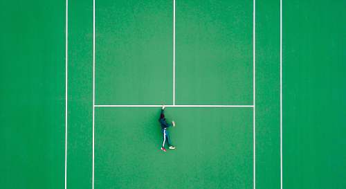tennis aerial photography of person lying on tennis court sport