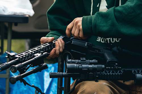 weapon person holding rifle weaponry