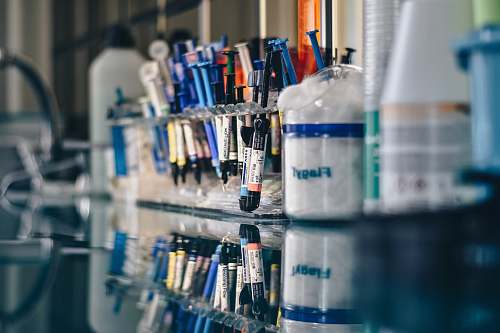hospital assorted-color syringes on clear glass rack lab