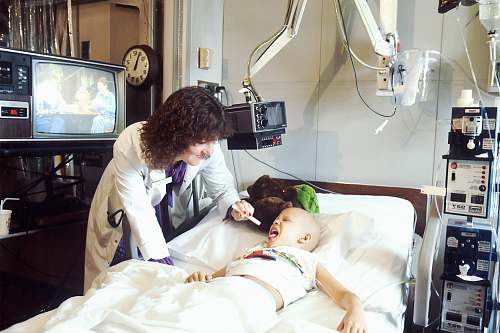 display A doctor examines a pediatric patient who is receiving chemotherapy. electronics