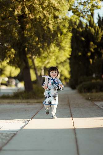 people girl walks on gray concrete pathway person