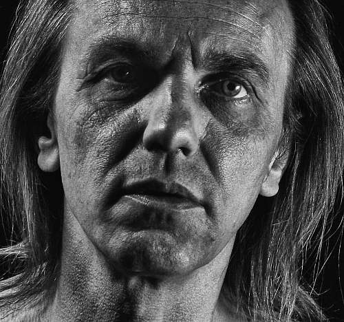 person grayscale photo of man's face black-and-white