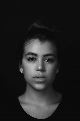 person grayscale photo of women's face black-and-white