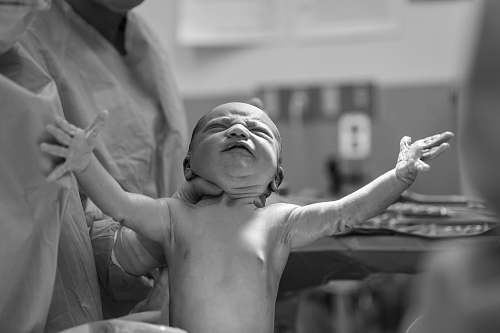 baby grayscale photography of a new born baby black-and-white