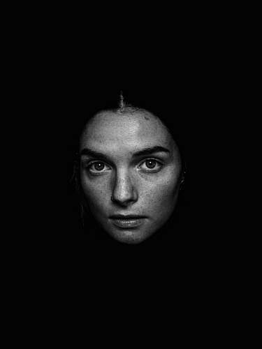 black-and-white grayscale photography of woman looking straight face