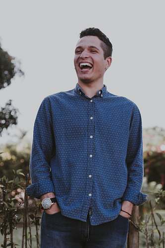 people man hands on both pockets while laughing person