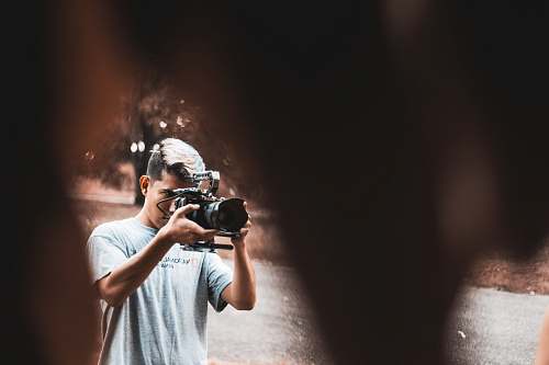 person man holding black camera camera