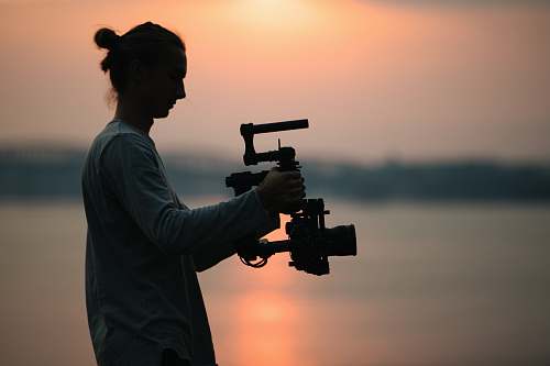 person man holding camera photography