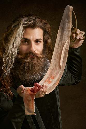 person man holding tong and textile with stains face