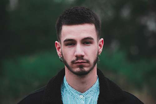 person man in black coat in selective focus photo apparel