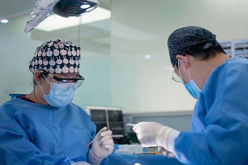 person man in blue dress shirt wearing black and white knit cap doctor