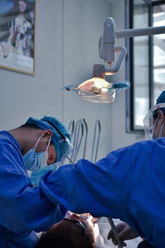 person man in blue scrub suit wearing white mask doctor