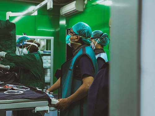 person man in blue shirt wearing green helmet clinic