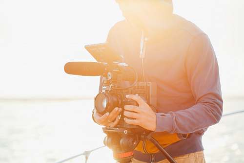 person man in jacket holds camera photo