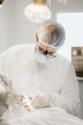 person man in white dress shirt wearing black framed eyeglasses clinic