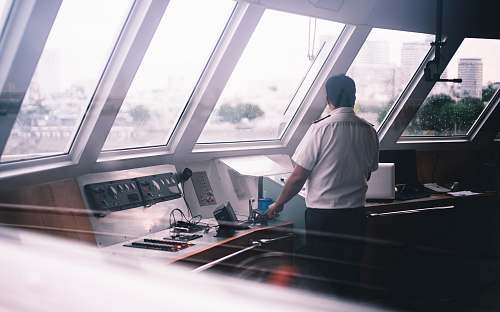 person man standing inside boat building
