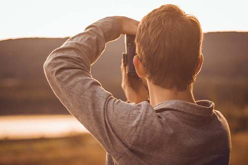 person man taking pictures with DSLR camera photo