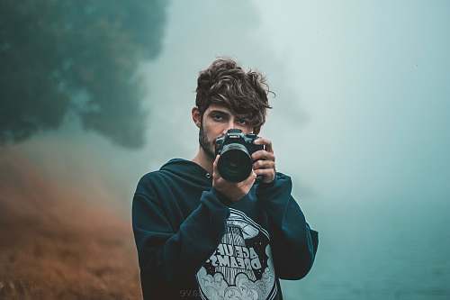 person men holding a camera close-up photography camera